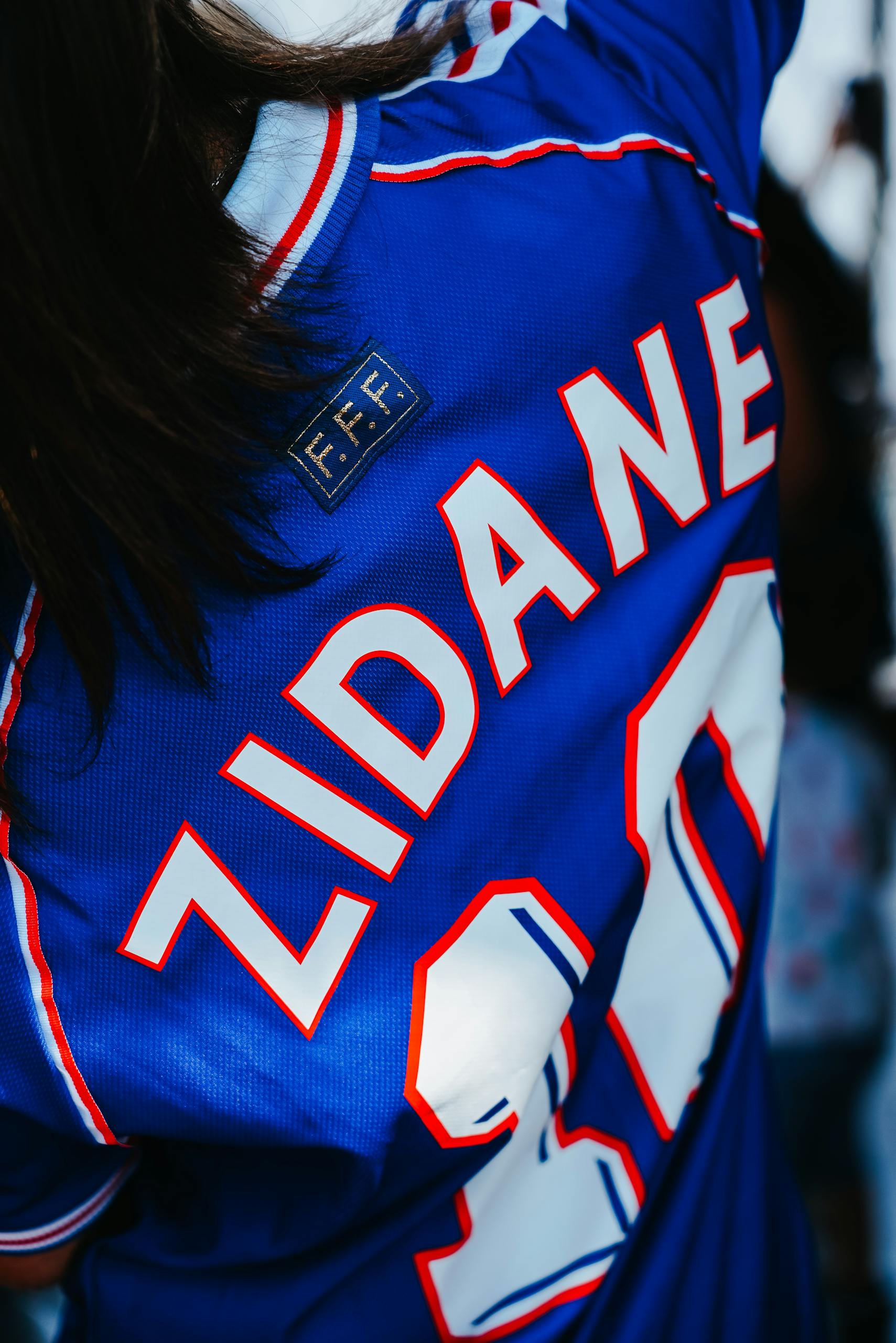 Detailed view of blue soccer jersey featuring a renowned player's name.